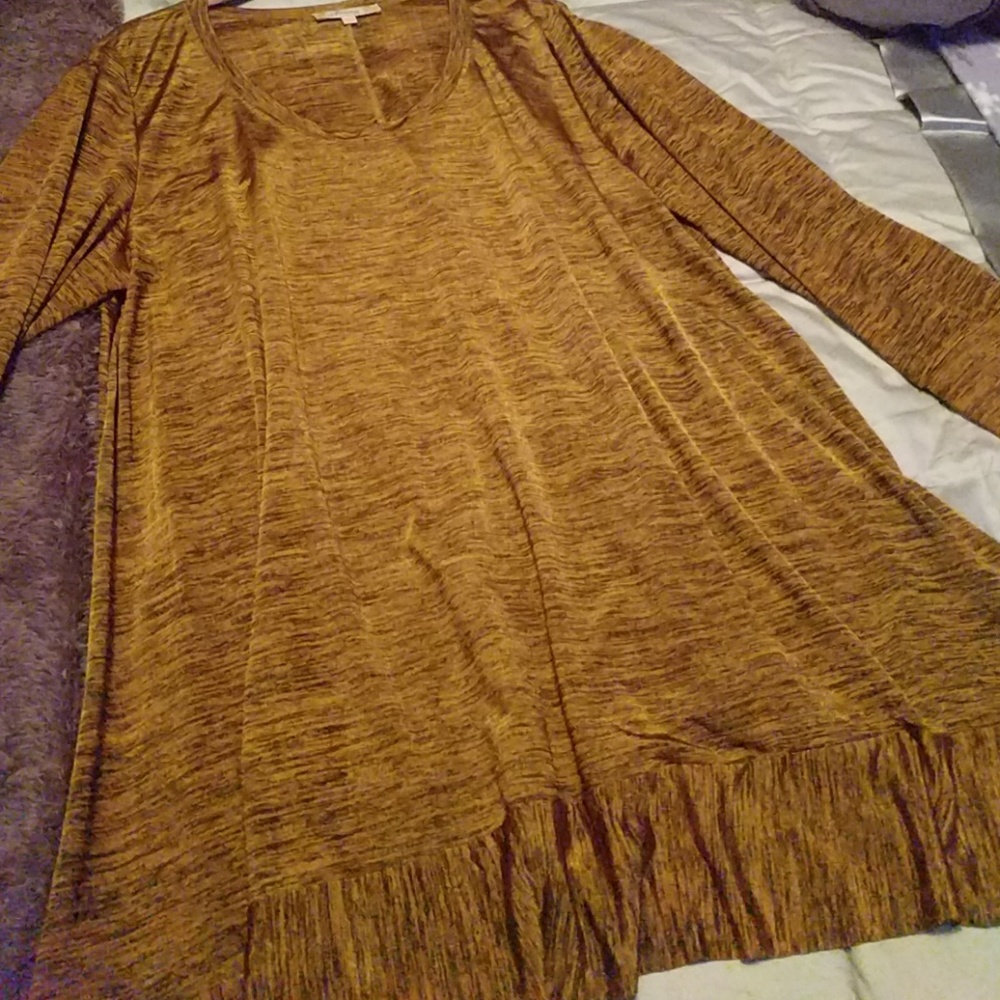 Gold and black tunic with ruffle edging.